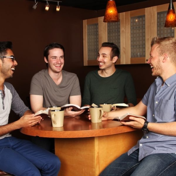 Diverse Group of Men in a Bible Study at a Cafe